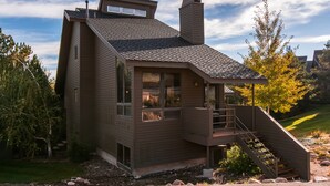 A modern house with a steeply pitched roof, large windows, and a prominent chimney. - Luxurious and modern townhome with a ton of room! (Park City)