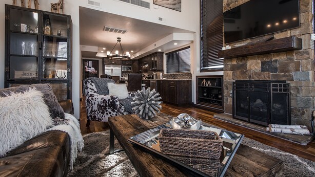 A spacious living room with a fireplace, a dining area, and a kitchen. - Luxurious and modern townhome with a ton of room! (Park City)
