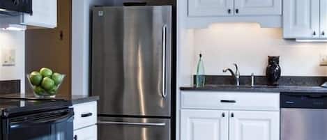 Enjoy meals in this fully equipped kitchen with a dining table set for a meal.