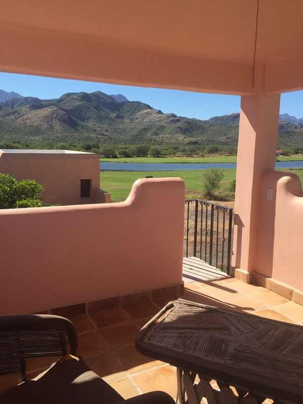 A balcony with a view of a lake and mountains.