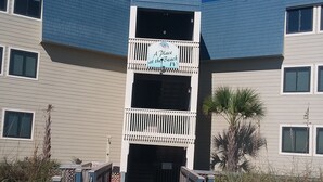 A building with a sign reading "A Place at the Beach IV."