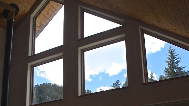 A spacious room with large windows, a fireplace, and a cozy seating area. - Beautiful Mountain Retreat Just Minutes From the Slopes!! (Taos Ski Valley)