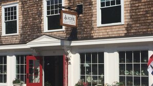 A building with a red door and a sign above it.