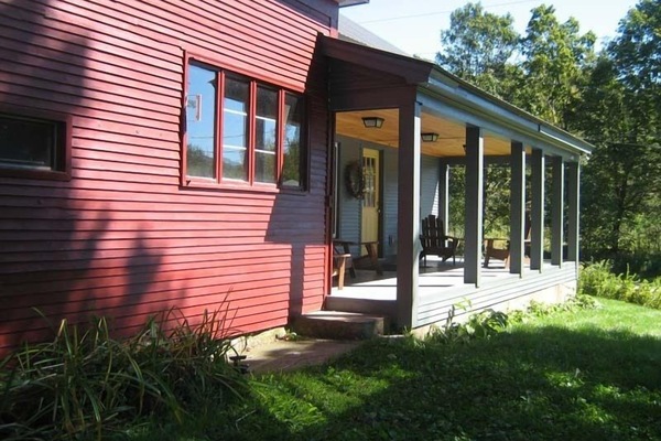 Porch with dining table and Adirondack chairs