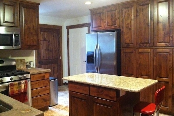 Fully oufitted gourmet kitchen with custom knotty alder cabinets.