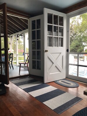 Enter a serene space with a beautifully designed entryway leading to a cozy porch area.