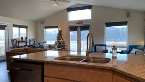 A spacious kitchen with a granite countertop, wooden cabinets, and a built-in dishwasher. - Expansive views, hot tub, & kid friendly! Perfect for multiple families! (Manson)