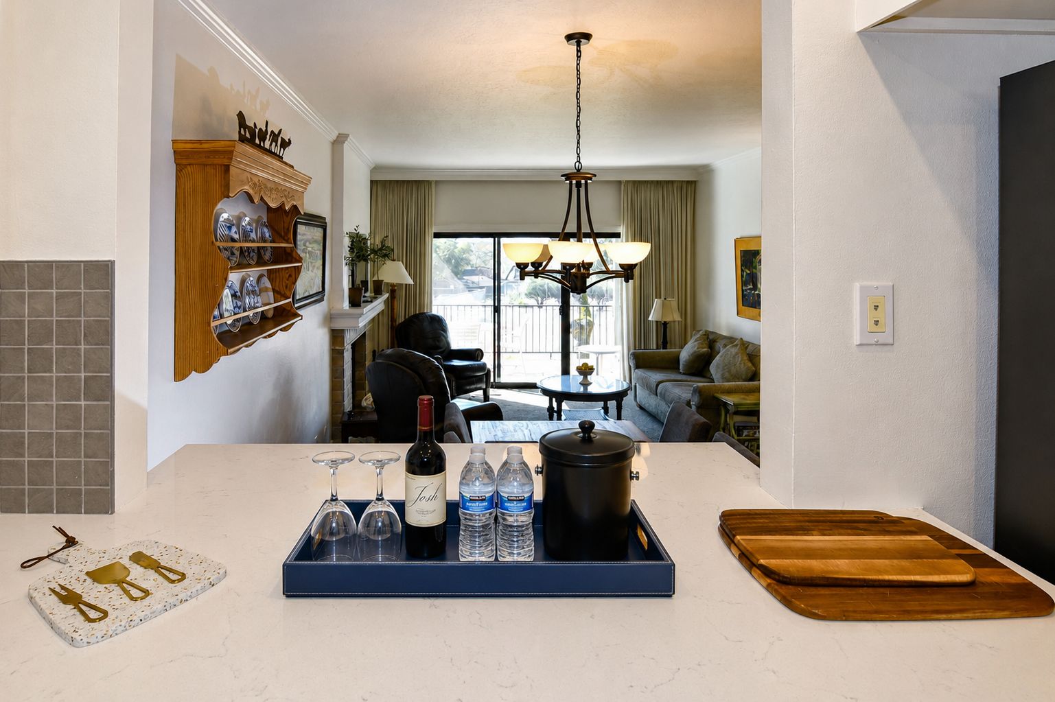 A kitchen with a dining area, a fireplace, and a view of the outdoors.