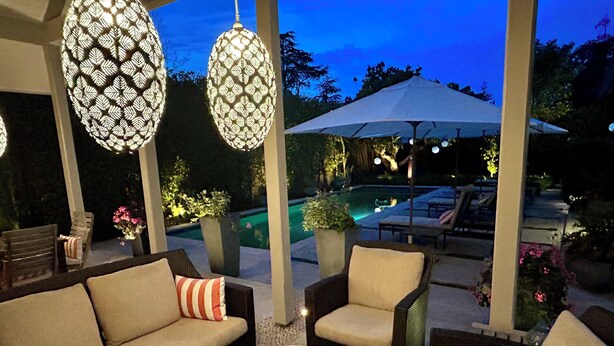 An outdoor seating area with wicker furniture and a pool in the background. - Spa-Like Paradise Walking Distance To Wineries,  Shops, No Final Cleaning Fee (St. Helena)