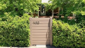A gated entrance with a number sign, surrounded by lush greenery. - Spa-Like Paradise Walking Distance To Wineries,  Shops, No Final Cleaning Fee (St. Helena)