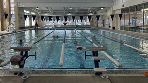 An indoor swimming pool with lanes, diving blocks, and a tiled floor. - Spa Cabin: Lakefront w Private Sauna & Hot Tub, Kayaks, Dock, 5 Star Clean Rated (Oakland)