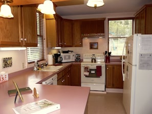 Enjoy cooking in this well-equipped kitchen with a stainless steel sink, microwave, and kettle.