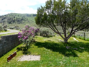 Relax in a serene landscaped garden with a tranquil atmosphere, complete with a bench for contemplation and scenic views.