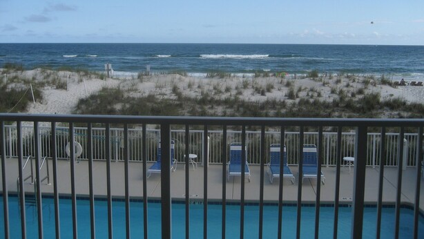 A poolside view with beach access, lounge chairs, and a clear view of the ocean. - Elevated First Floor Beachfront w/ Beautiful Balcony Views (Gulf Shores)