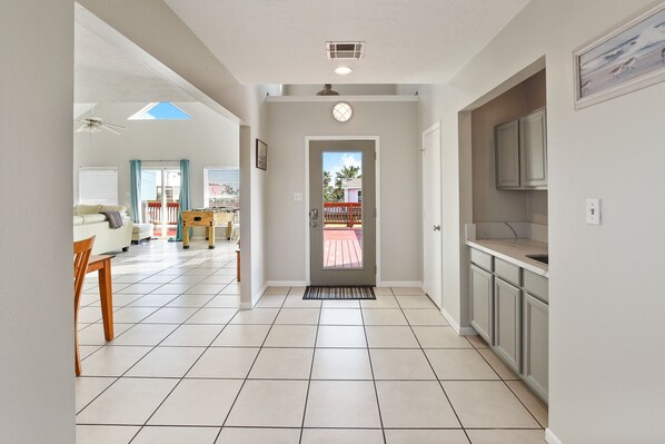 A modern kitchen with a built-in oven and a dining area with a table and chairs.