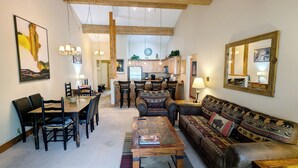 A spacious living area with a dining table, chairs, a sofa, and a coffee table. - Remodeled Condo w/ FREE WiFi, Parking, Heated Pool, Hot Tubs, Skier Shuttles (Avon)