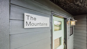 A sign reading "The Mountains" on a building's exterior wall. - Nye Beach, Restaurants, Shop! Walk to the Beach! (Newport)