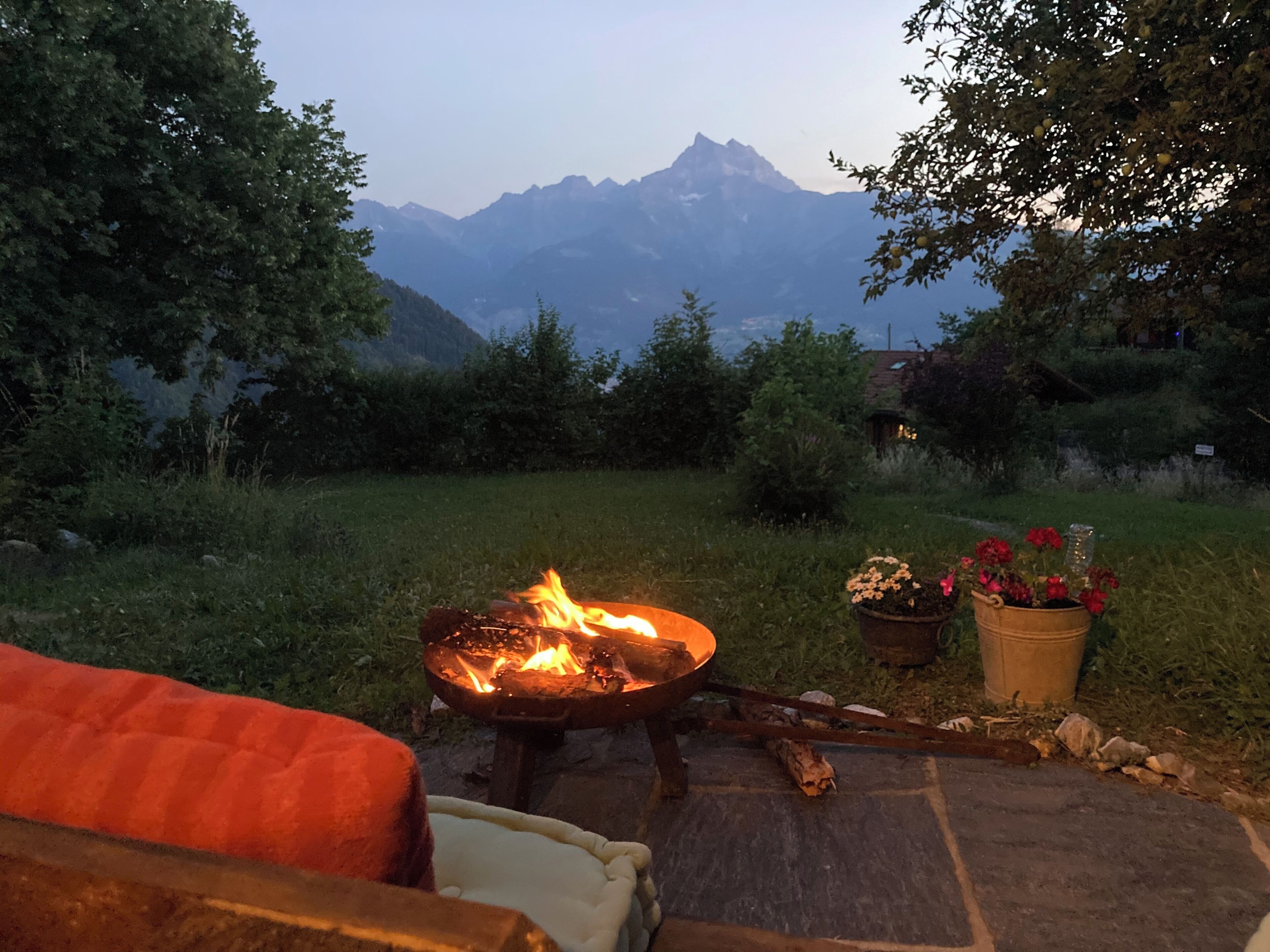 A fire pit with a view of mountains in the background.