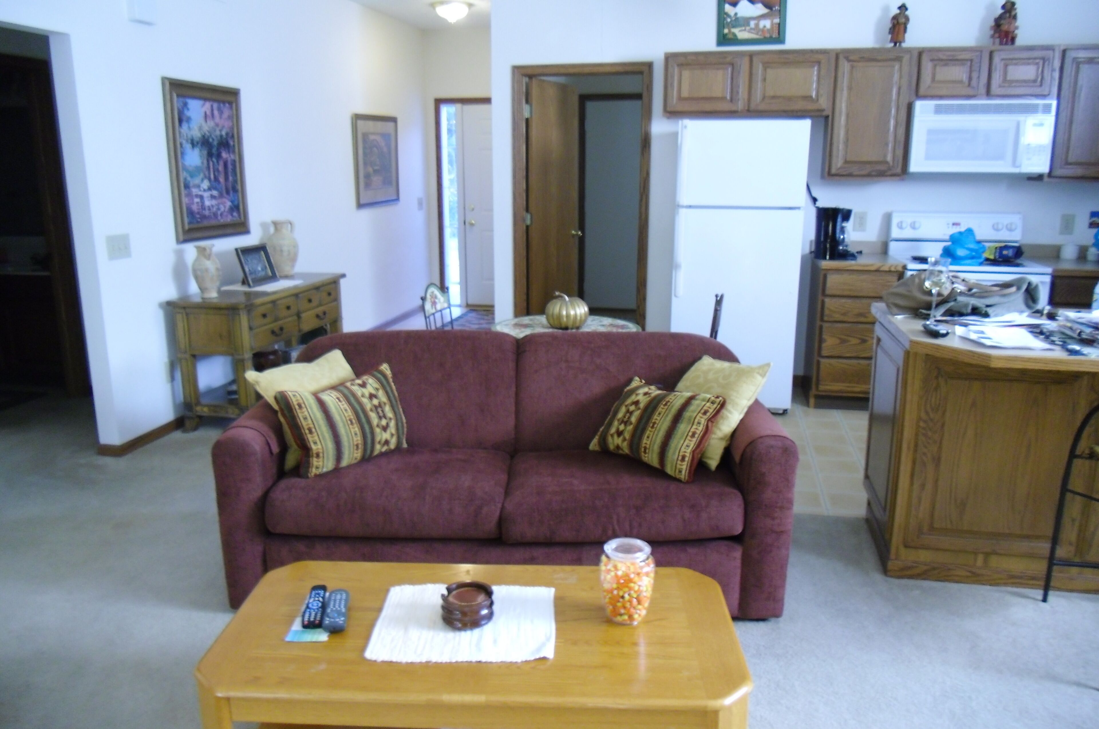 Living Room w/front entrance in background--partial kitchen/bar
