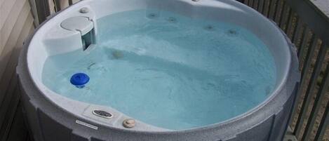 A hot tub on a wooden deck.