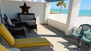 A covered outdoor seating area with lounge chairs and a star decoration.