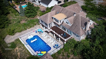 Aerial view of back of house (pool, shuffle board court, deck)