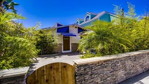 Surrounded by lush greenery, this two-story house offers a serene and atmosphere.