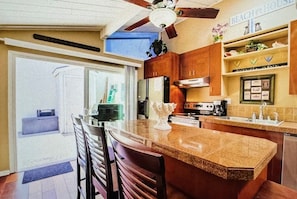 Enjoy cooking in this well-equipped kitchen with a central island, oven, and sink.