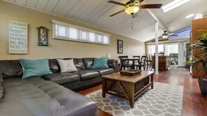 Relax in this stylish living area with a large sofa, coffee table, and patterned rug.
