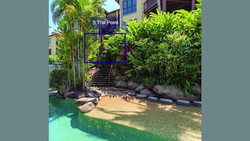 Stroll through lush gardens, surrounded by a variety of plants and a small water feature.