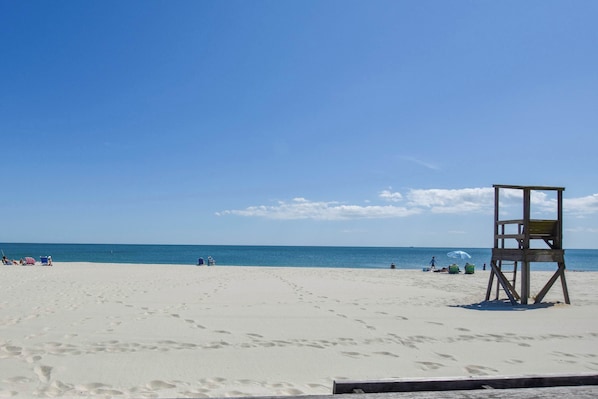 A beach with a lifeguard tower, sandy beach, and ocean. - Spacious w/ Basketball Court & Playground! (Harwich)