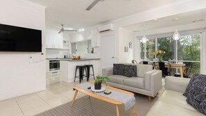 Relax in this stylish living space with a large flat-screen TV, kitchenette, and dining area for two.