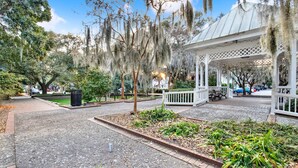 A gazebo with a white lattice roof and a brick pathway leading to it. - Heated Pool Access | 5*Clean | Flex Cancelation (Savannah)