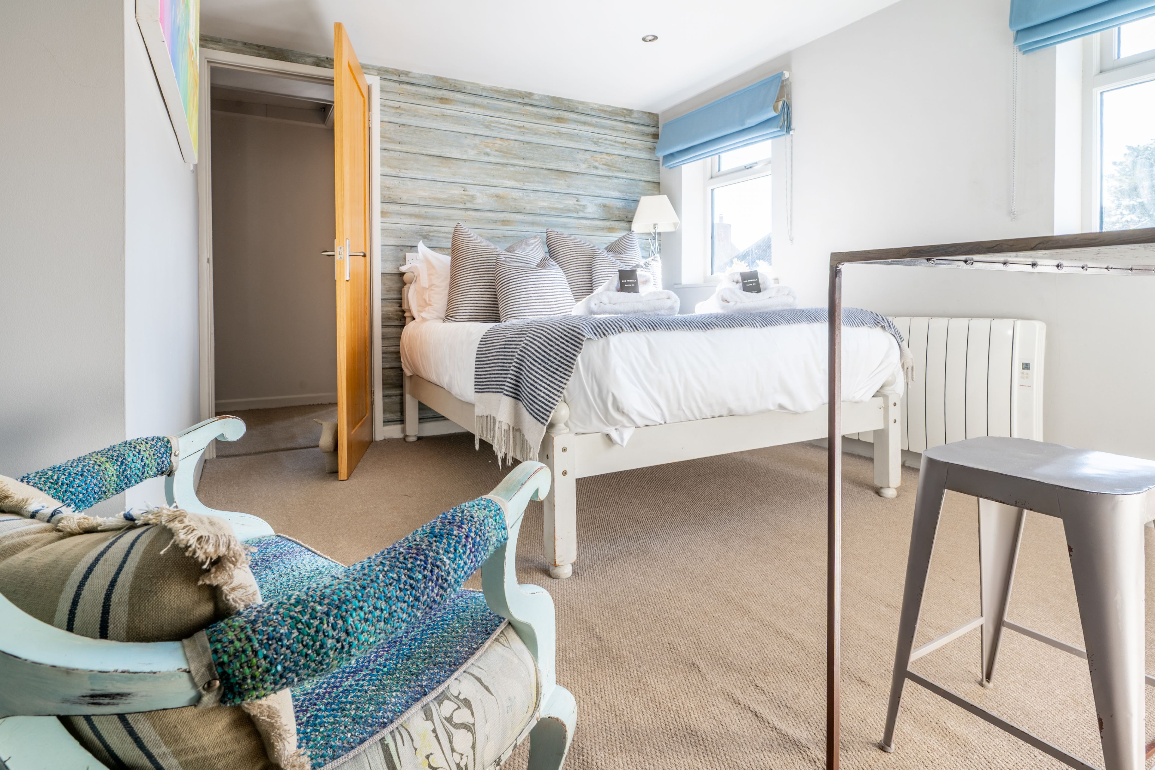 Une chambre à coucher avec un lit, un bureau, une chaise et un radiateur.