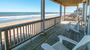 A wooden deck with white chairs overlooking a beach. - 2875 - MOJO'S, Duck Beachfront Home w/ Pool Table & Views (Duck)