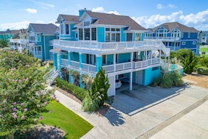 A multi-story residential building with balconies and a covered patio area.