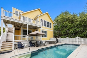 A two-story house with a pool, outdoor furniture, and a covered patio area. - 1820 - The Thirsty Duffer, Currituck Club Retreat | Pool, Hot Tub & Golf (Corolla)