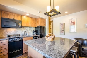 Enjoy cooking and dining in this well-equipped kitchen with a large island and appliances.
