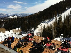 Enjoy meals with breathtaking views of the snow-covered slopes and distant mountains from this elevated dining area.