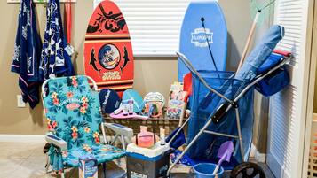 Relax in a beach-inspired retreat with a comfortable chair, surfboard, and baby essentials at your fingertips.