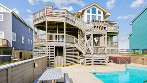 A two-story wooden house with a balcony and a swimming pool in the backyard. - 5690- Brown Pelican - Spacious Oceanfront Nags Head Retreat (Nags Head)