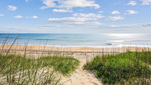 A beach path leading to the ocean with a clear sky and calm sea. - 5690- Brown Pelican - Spacious Oceanfront Nags Head Retreat (Nags Head)