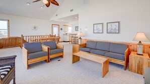 A spacious living area with a high ceiling, wooden furniture, and a ceiling fan. - 6285-Tidal Song, | Oceanside | South Nags Head | Sleeps 8 (Nags Head)