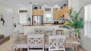A modern kitchen with wooden cabinets, stainless steel appliances, and a central island. - Waterfront Townhome with Boat Slip & Pool Access (Marathon)
