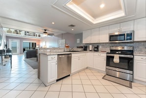 Enjoy cooking in this well-equipped kitchen with a central island, oven, and microwave.