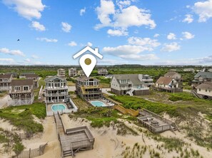 A coastal residential area with multiple houses, a swimming pool, and a beach access area. - 5785- Southern Comfort - South Nags Head Oceanfront Retreat (Nags Head)