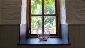 A window with a wooden frame and a white painted wall. - A characterful former Carriage House, located in peaceful scenic countryside (Cellan)