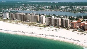 A coastal hotel complex with multiple high-rise buildings, a beachfront, and a marina.