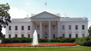 A large white building with a central entrance, columns, and an American flag. - Hidden Hollow Farm - Pool; Game Rm; Sleeps 26, 45 min. to DC, Weddings/Corporate (Warrenton)