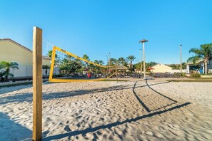 Enjoy a game of volleyball on the sandy court surrounded by palm trees and ocean views.